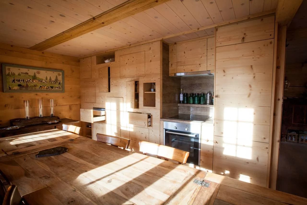 Cuisine et rangements intégrés en bois clair dans un intérieur alpin